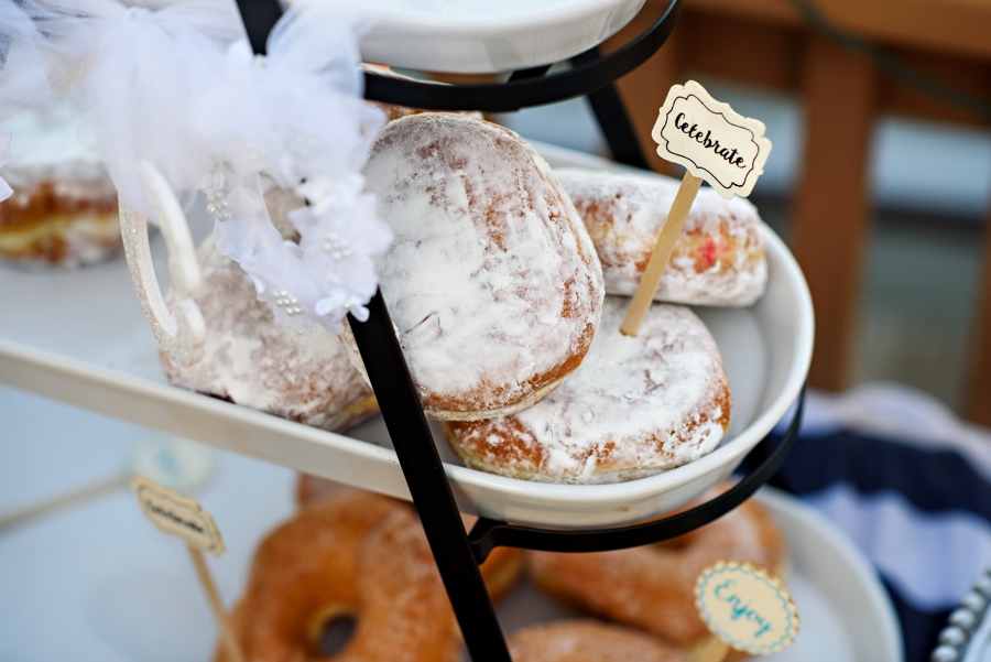 Donuts at a wedding with a sign that says celebrate.